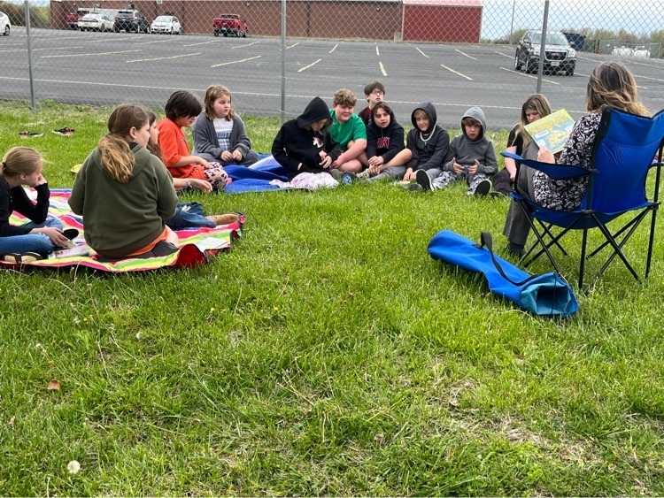 PHES library reading outside for Earth Day.