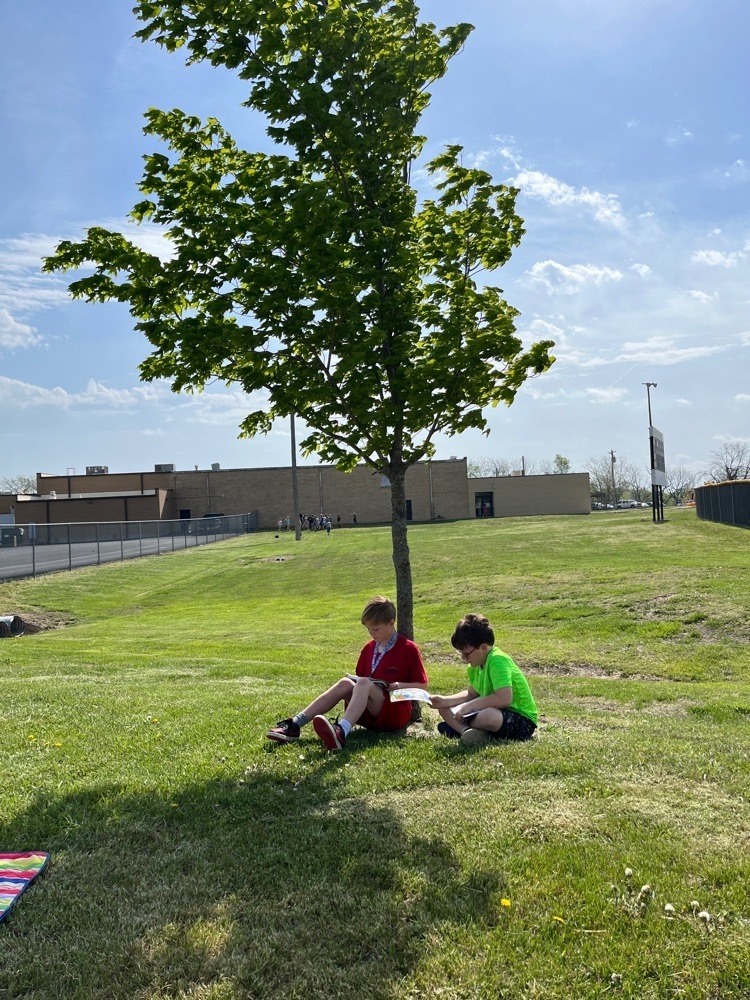 PHES library reading outside for Earth Day.