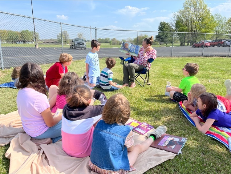 PHES library reading outside for Earth Day.